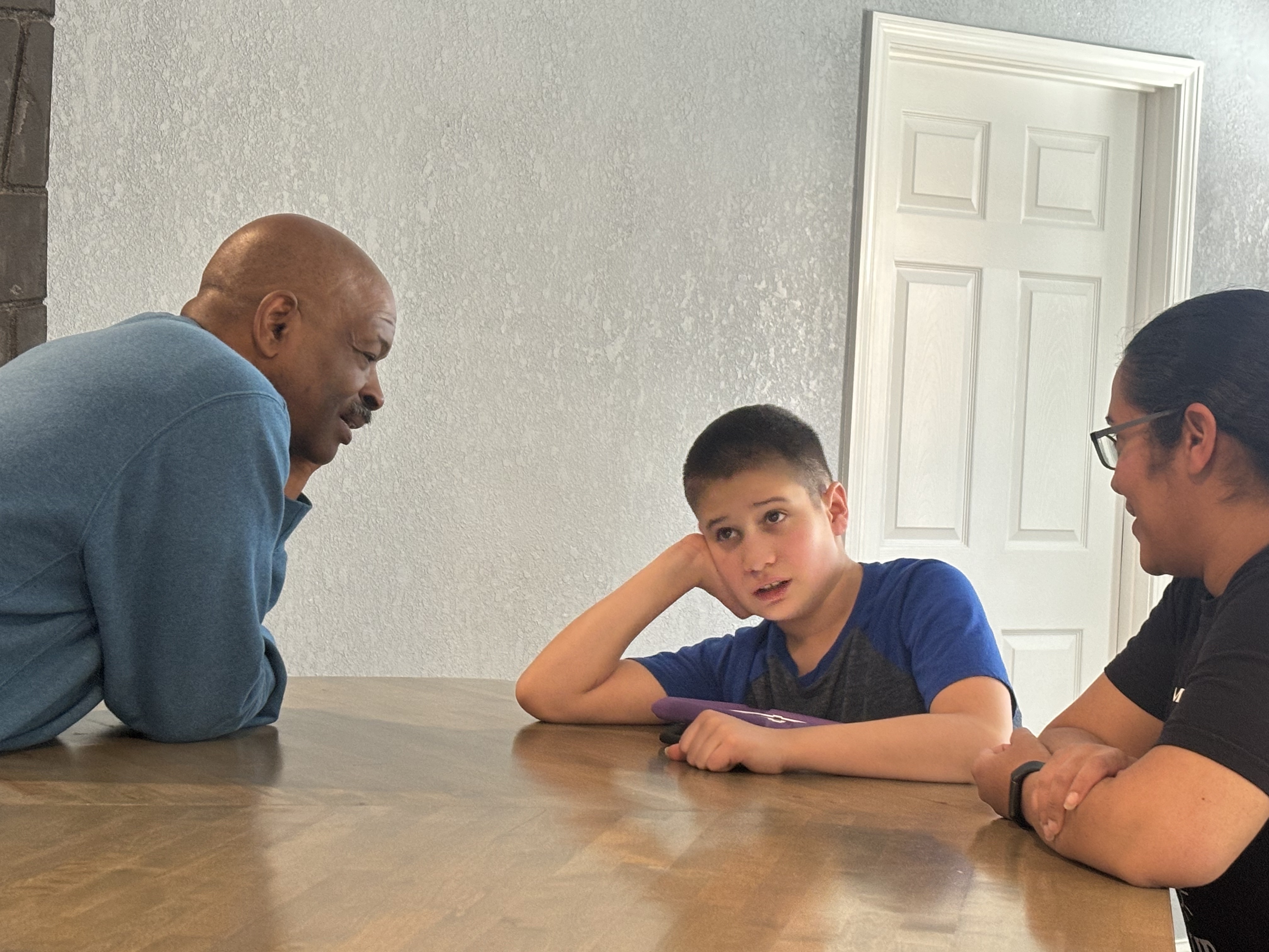Navigation A young boy and his mother receiving navigation from Robert. Robert and the mom are smiling at the little boy who is looking at Robert.